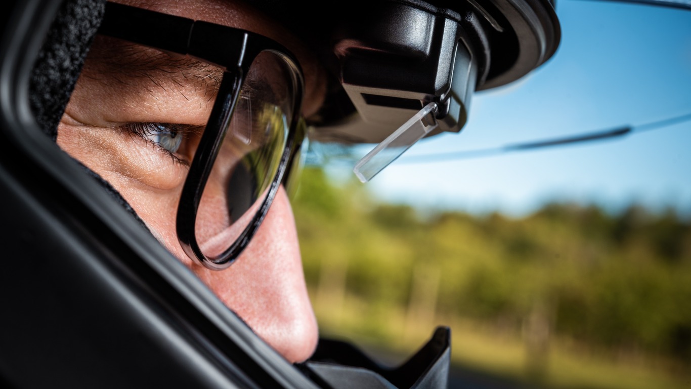 Motorcyclist with helmet and DVISION head-up display looks ahead to the road ahead.
